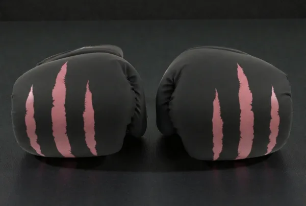 Predator Series pink accent 10oz girls boxing gloves shown from the front knuckle angle.