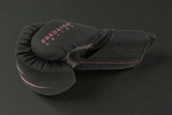 Side profile of the Predator Series pink accent 10oz womens boxing glove showing series branding.