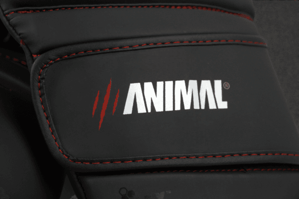 Close-up of the Animal Athletics logo on the wrist strap of the Predator Series red accent boxing gloves.