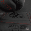 Close-up of ApeGrip V2 and MatteSkin branding on the Predator Series red accent boxing gloves.