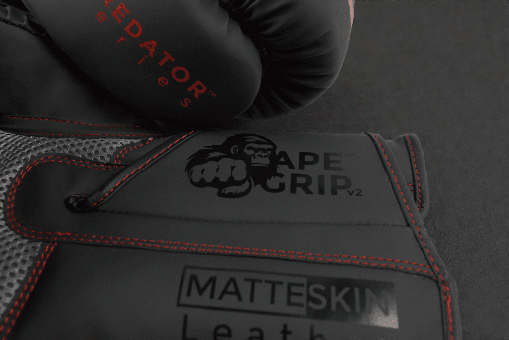 Predator Series Boxing Gloves – Branding Close-up Close-up of ApeGrip V2 and MatteSkin branding on the Predator Series red accent boxing gloves.