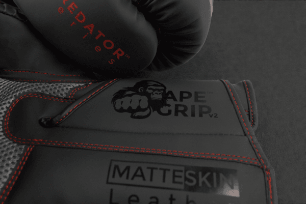 Close-up of ApeGrip V2 and MatteSkin branding on the Predator Series red accent boxing gloves.