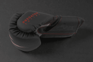 Side profile of a Predator Series red accent 14oz boxing glove showing the Predator Series branding.