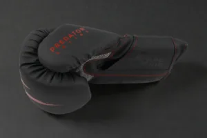 Side profile of a Predator Series red accent 14oz boxing glove showing the Predator Series branding.