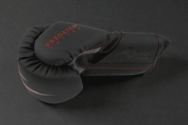 Side profile of a Predator Series red accent 14oz boxing glove showing the Predator Series branding.