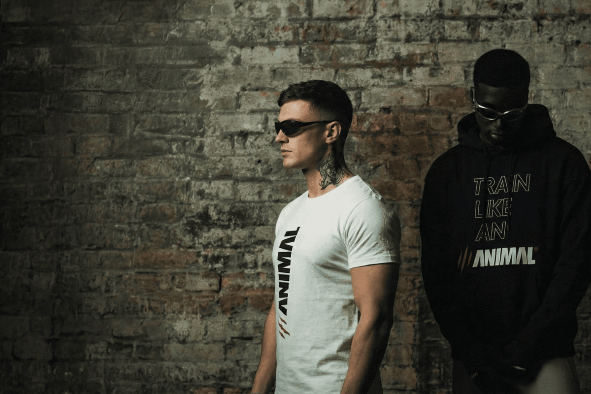 Two male models wearing Animal Athletics Predator Series hoodie and t-shirt in an editorial studio setting