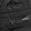 Close-up of ApeGrip V2 and MatteSkin leather branding on the Predator Series black accent boxing gloves.