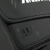 Close-up of the HexLayer padding logo on the Predator Series black accent boxing gloves.