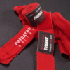 Close-up of the Predator Series red boxing hand wraps showing stitching, weave texture and product label.