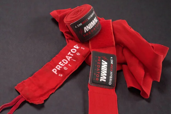 Close-up of the Predator Series red boxing hand wraps showing stitching, weave texture and product label.