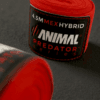 Detailed view of the Predator Series red boxing hand wrap fabric and ribbed thread pattern.
