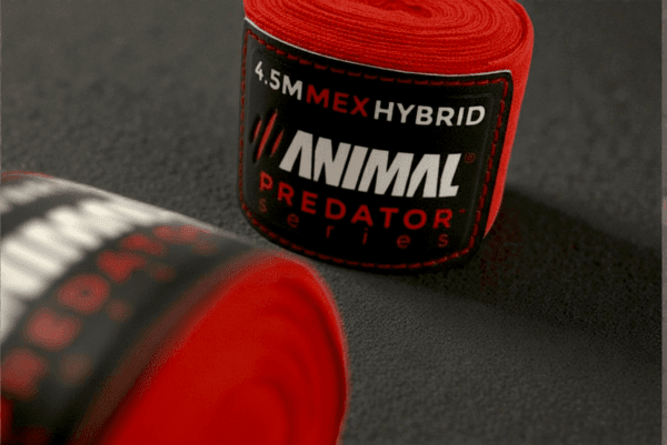 Detailed view of the Predator Series red boxing hand wrap fabric and ribbed thread pattern.